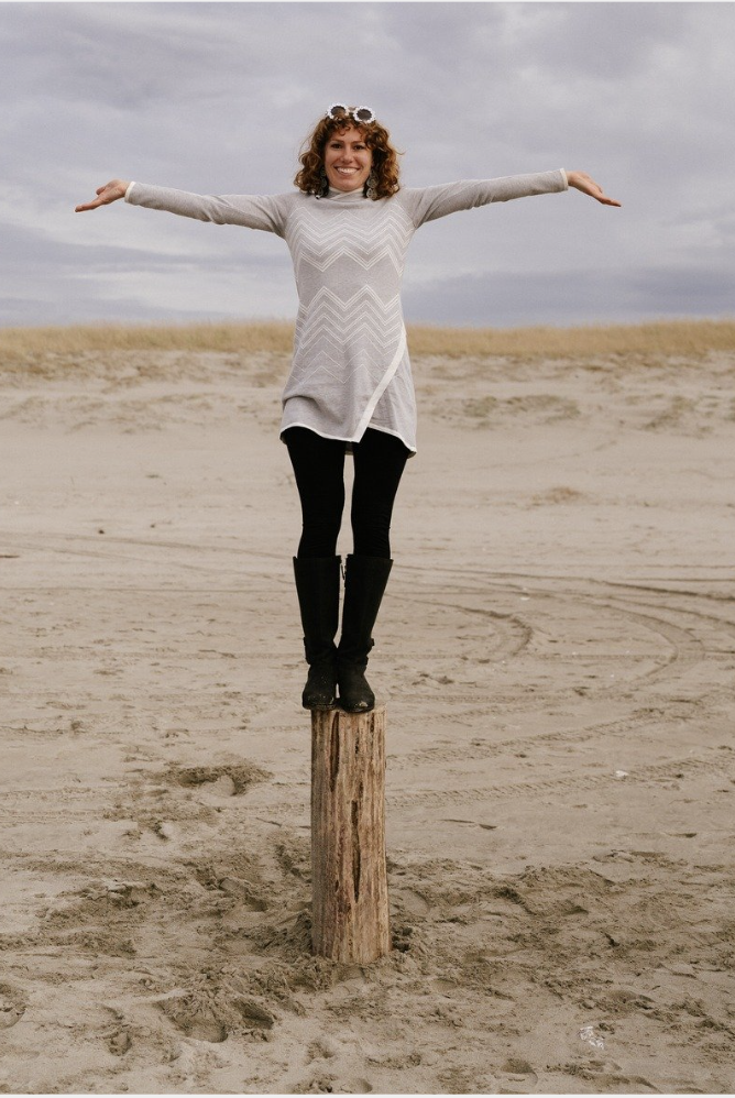 Standing on a log at the beach